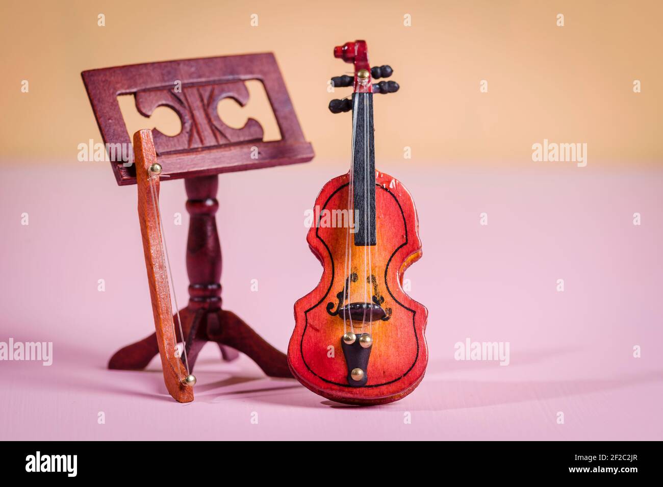 A miniature violin for a dollhouse Stock Photo