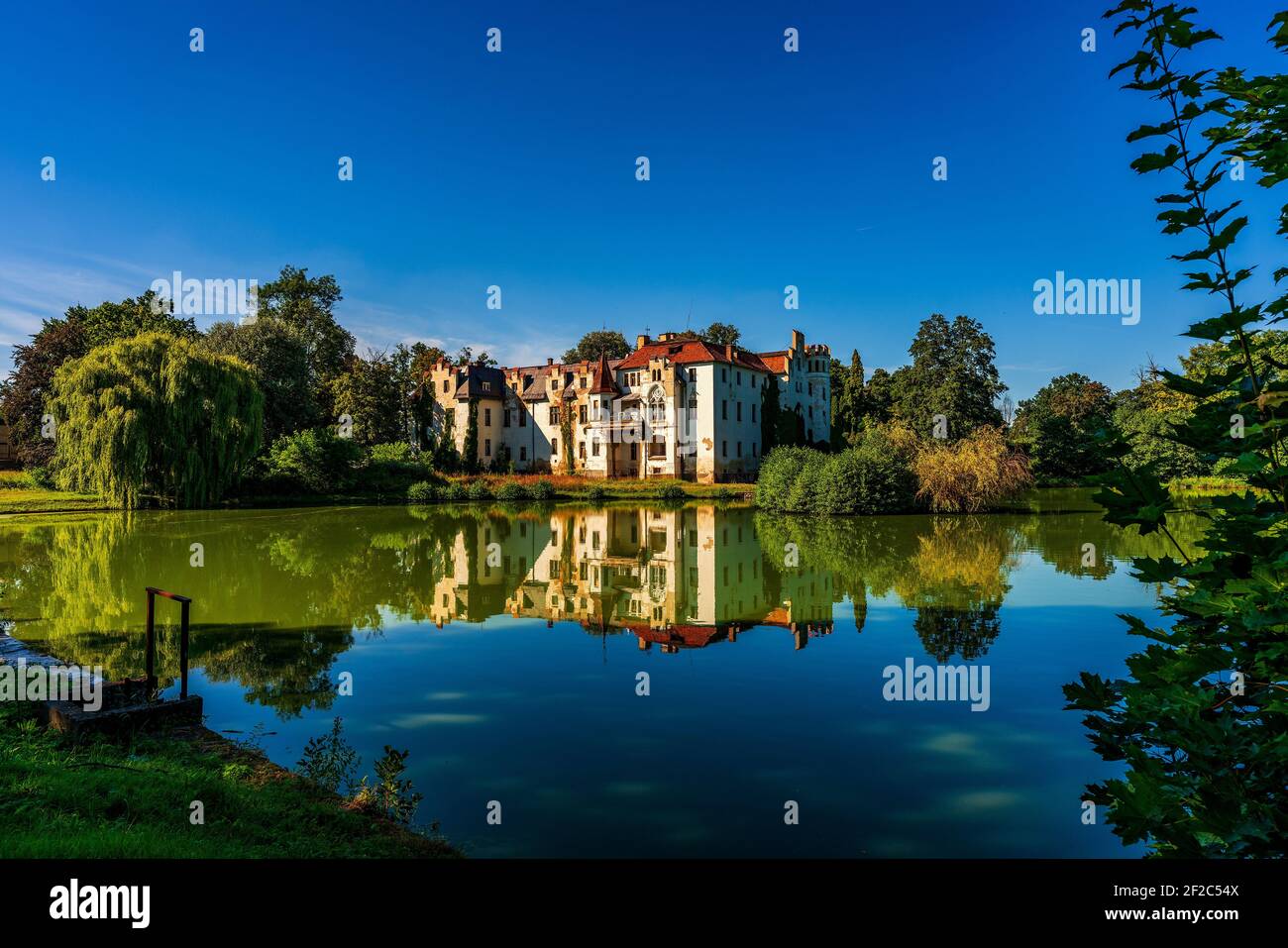 Güttmannsdorf Castle, a neo-Gothic castle on a small lake in Dobrocin, Poland. Stock Photo