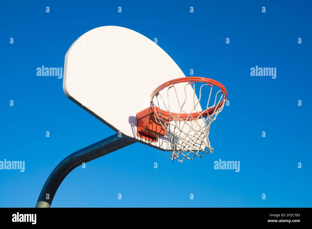 Basketball hoop on blue sky background in th school yard Stock Photo