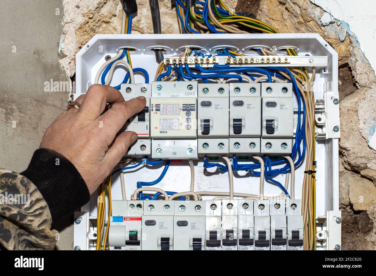 The electrician turns off the input automatic toggle switch of the