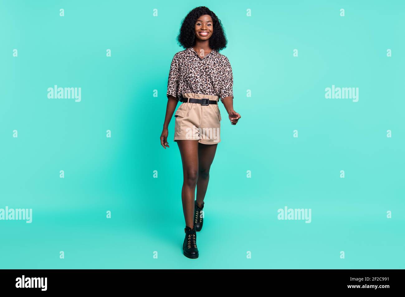 Photo of cute lovely lady walk wear leopard print shirt shorts belt  footwear isolated turquoise color background Stock Photo - Alamy