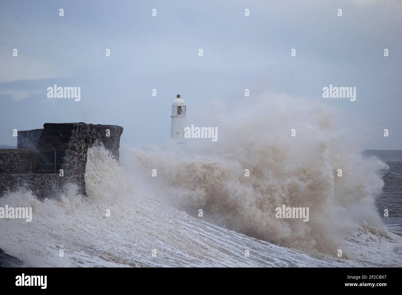 A view of Porthcawl Lighthouse during high tide and strong winds of 67mph hit the South Wales Coast on the 11th March 2021. Credit: Lewis Mitchell Stock Photo