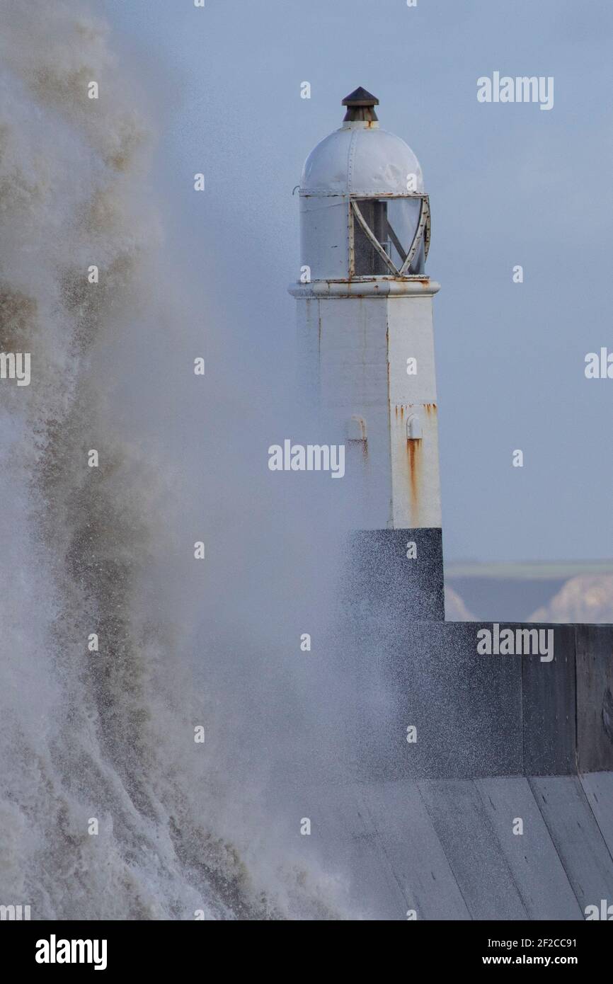 A view of Porthcawl Lighthouse during high tide and strong winds of 67mph hit the South Wales Coast on the 11th March 2021. Credit: Lewis Mitchell Stock Photo