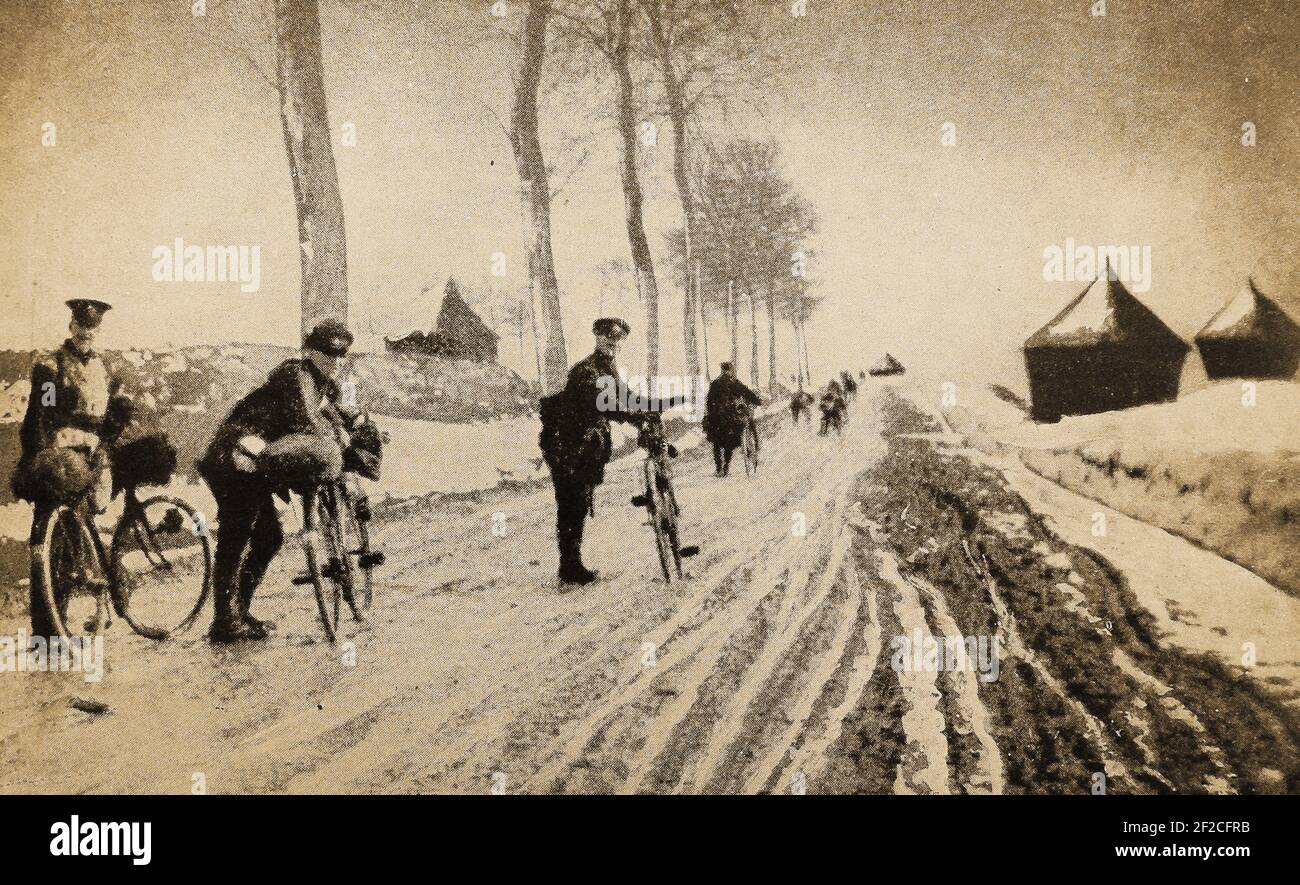 WWI - A wartime snapshot of men of the British Cyclist Corps negotiating snow covered French roads behind the lines in 1916. Volunteer cyclist units were formed as early the 1880s, with the   26th Middlesex Rifle Volunteers( the first  complete bicycle unit) being formed in 1888.  The Haldane reforms in 1908 reorganised the volunteers into the Territorial Force, nine battalions of cyclists were formed and others followed.  By the First World War the Territorial Force had  a strength of fourteen cyclist  battalions. All corps were disbanded by  1922 or converted to normal units. Stock Photo