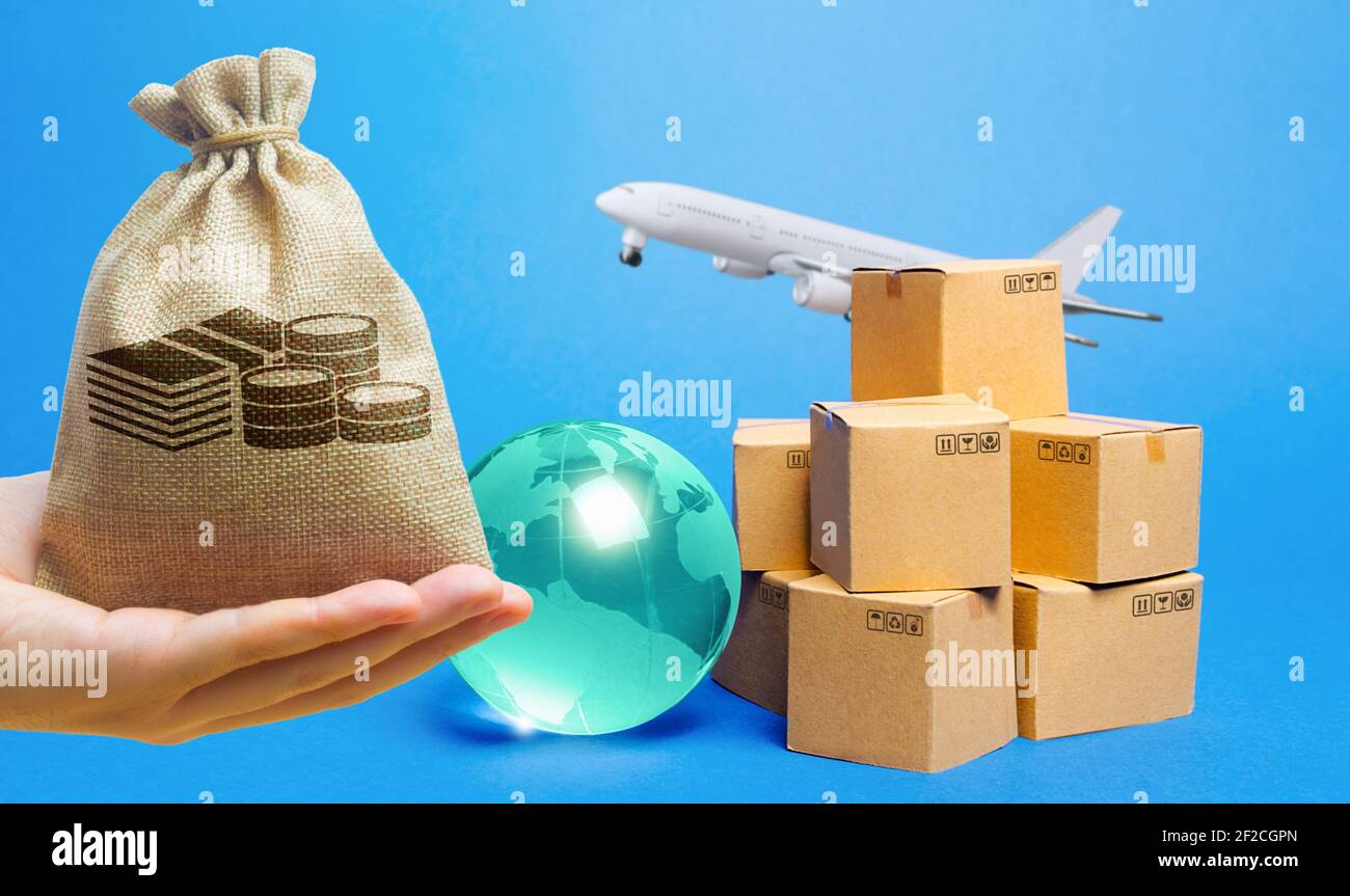 Money bag, blue globe, cardboard boxes and freight airplane. International world trade. Deliver goods, shipping. Import export freight traffic. Market Stock Photo