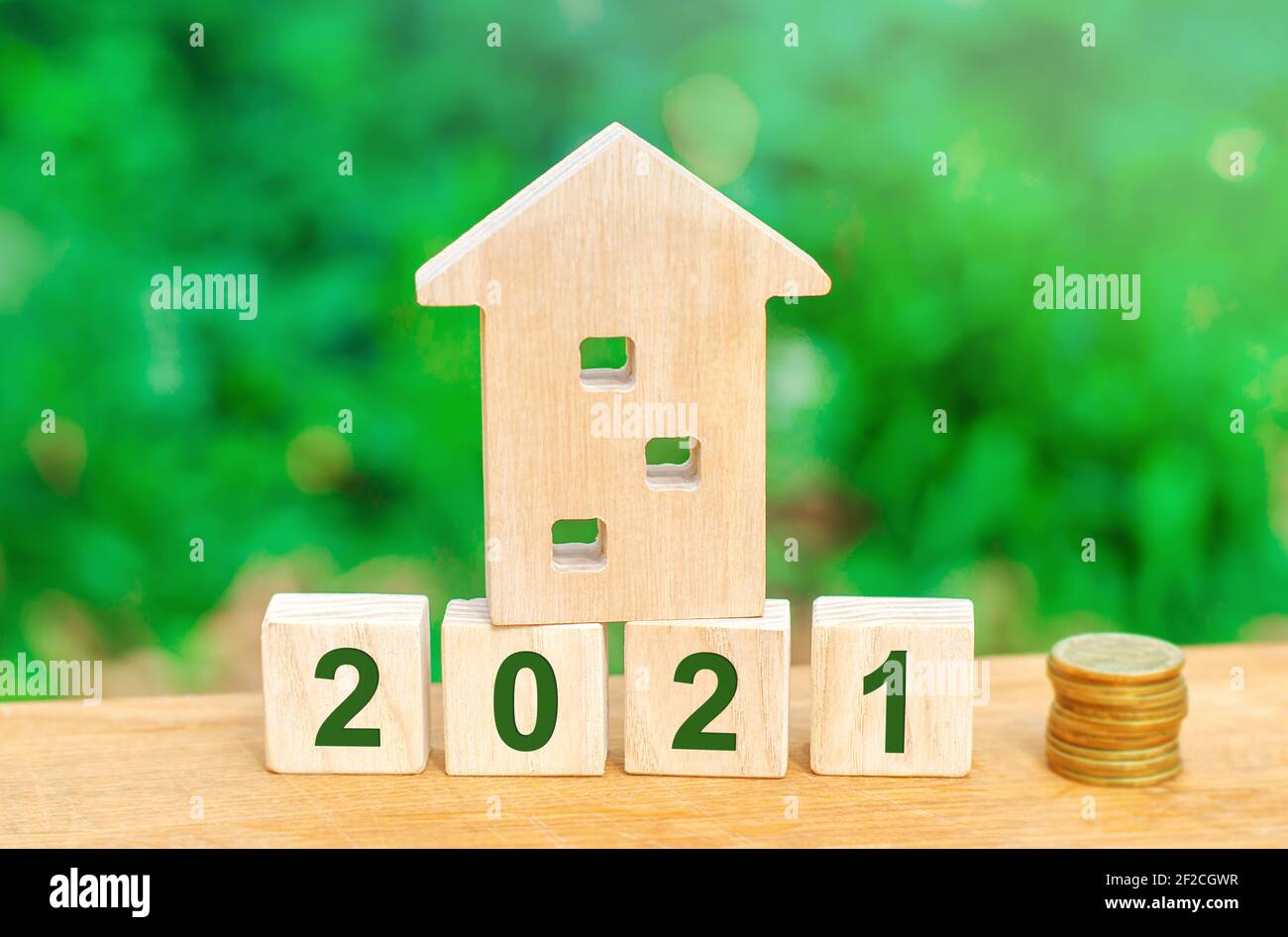 2021 wooden blocks and miniature house. Real estate concept. Family budget planning. Investments, plans, savings. Mortgage and mortgage rates. Forecas Stock Photo