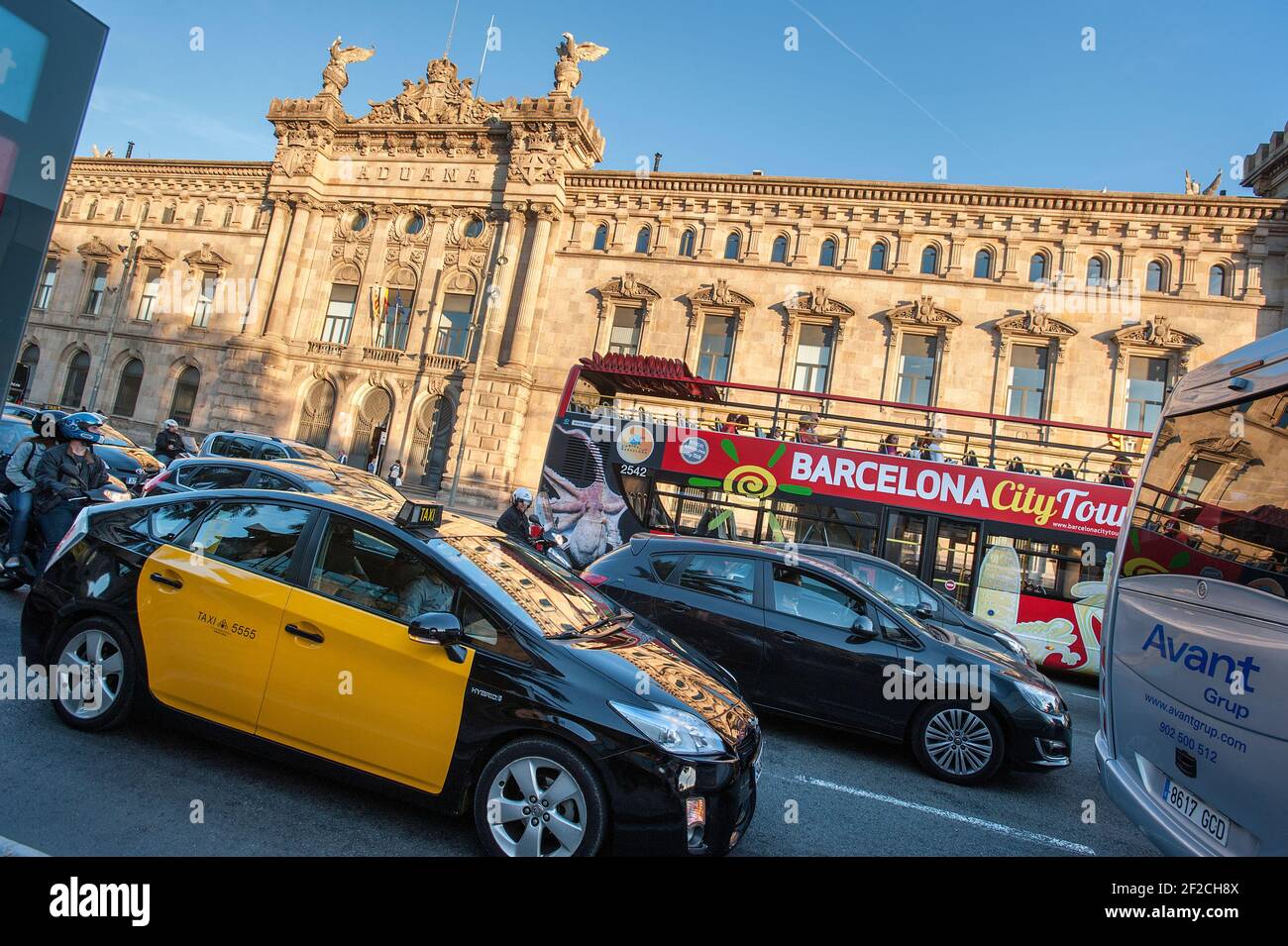 Port Customs building with taxi and City tour open top bus, Barcelona, Catalonia, Spain Stock Photo
