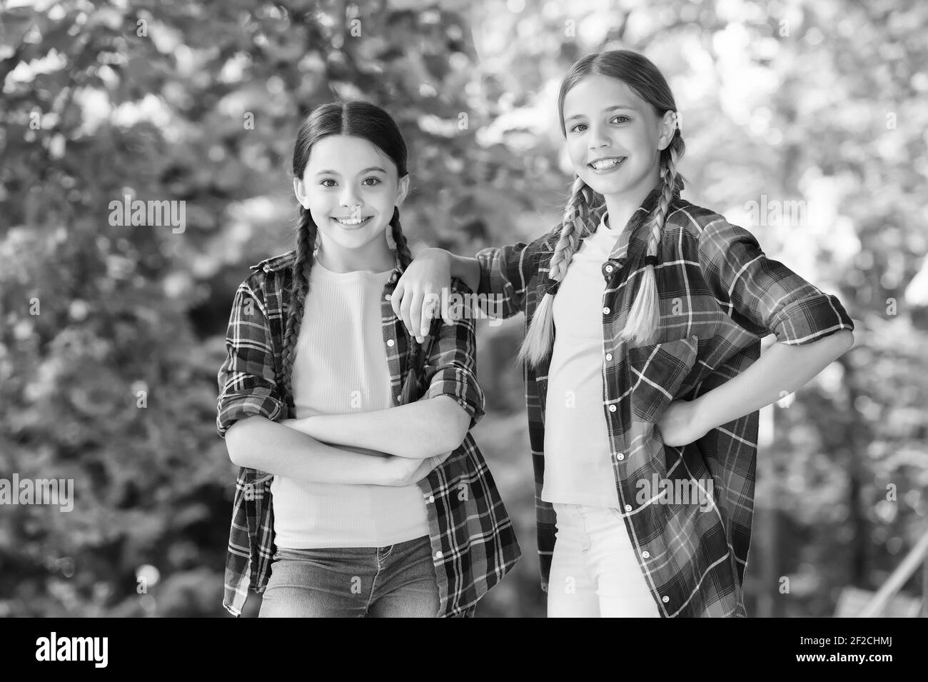 we are one. kid casual fashion. childhood happiness. happy childrens day. spend time and have fun together. best school friends. concept of friendship. small happy girls wear checkered shirt. Stock Photo