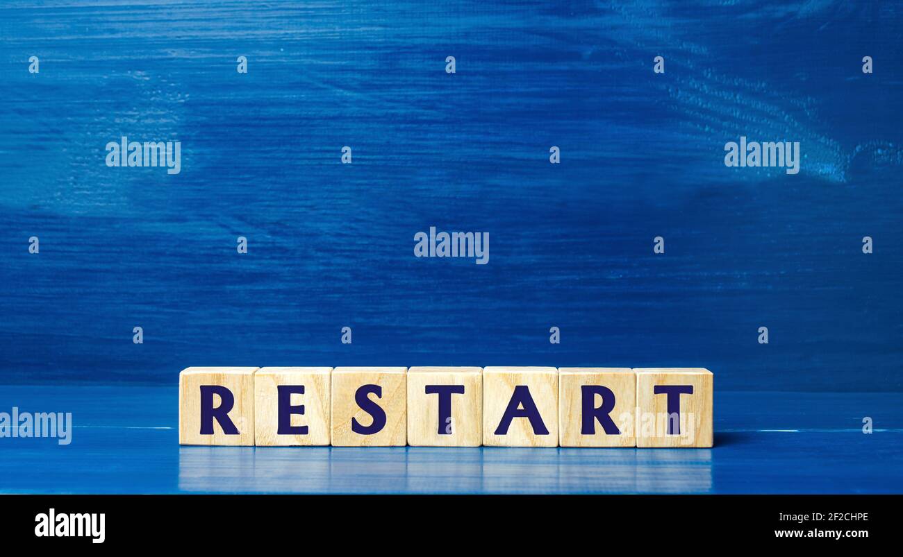 Wooden blocks with the word Restart. New beginning and launch. Start of a new process. Back to the roots. Business concept. Start again. Renewal Stock Photo