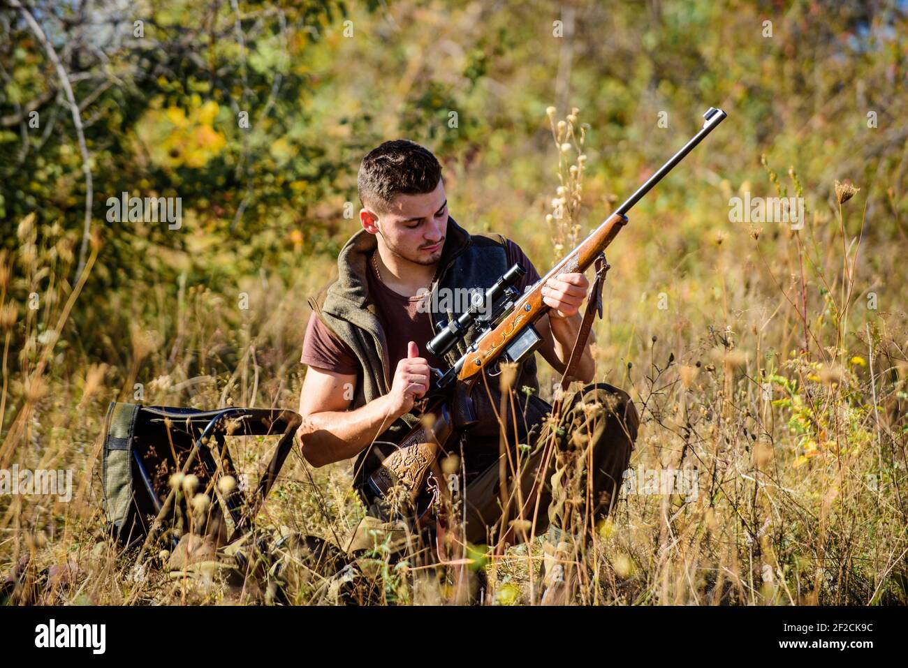 Hunting shooting trophy. Hunting hobby and leisure. Man charging hunting  rifle. Hunting equipment concept. Hunter with rifle looking for animal  Stock Photo - Alamy