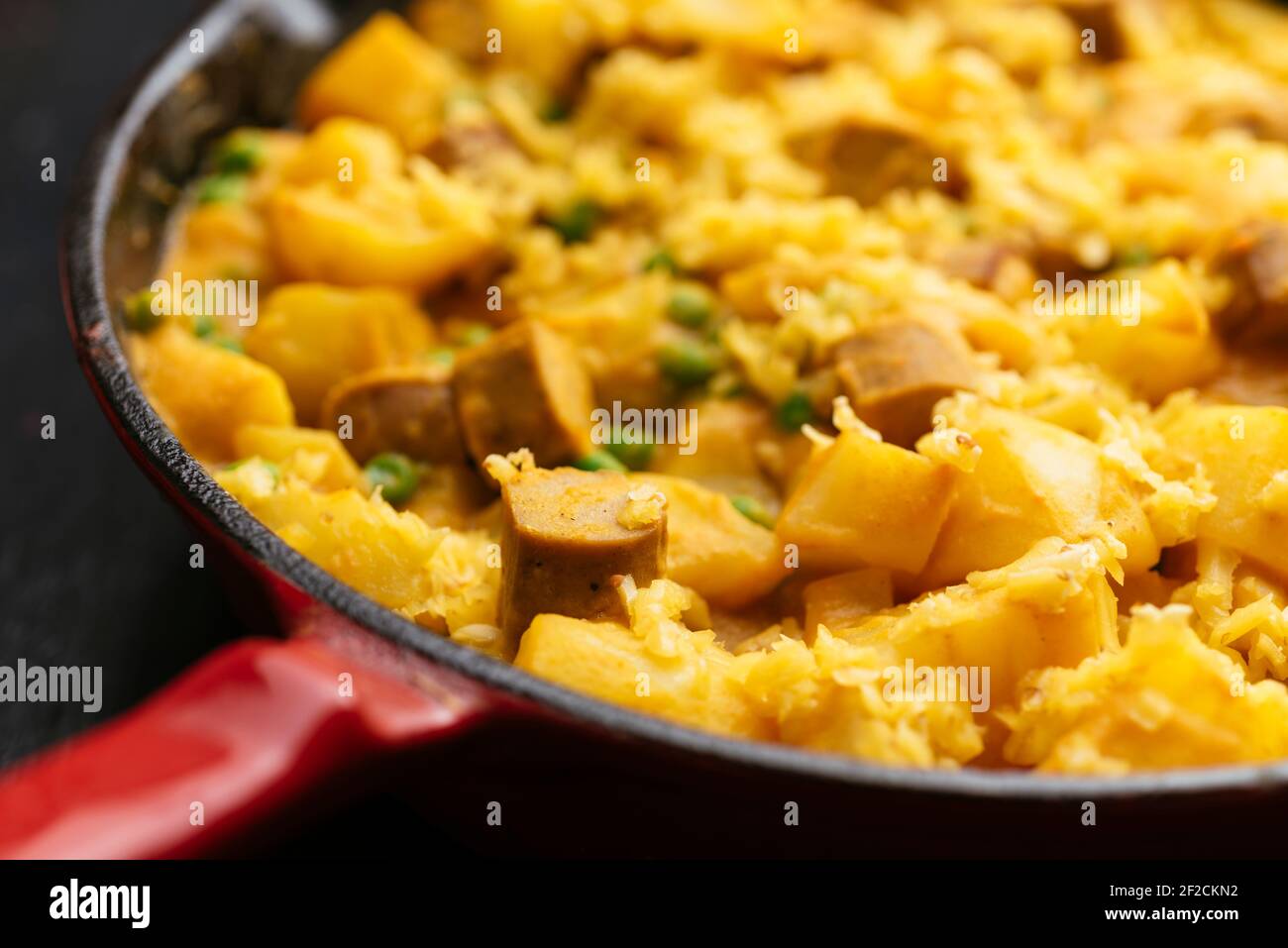 Vegan Hot Dog, Potato, Pea Dinner with Cheesy Sauce Stock Photo