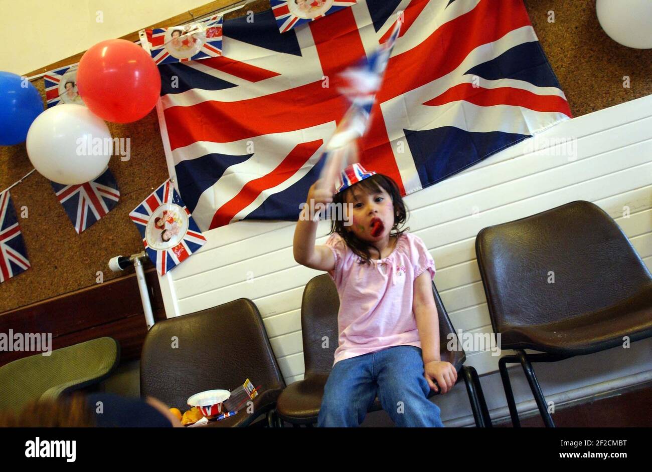 A child at the Chandos Centre in Stratford at the end of a busy day celebrating the Queen's Golden Jubilee.3 June 2002 photo Andy Paradise Stock Photo