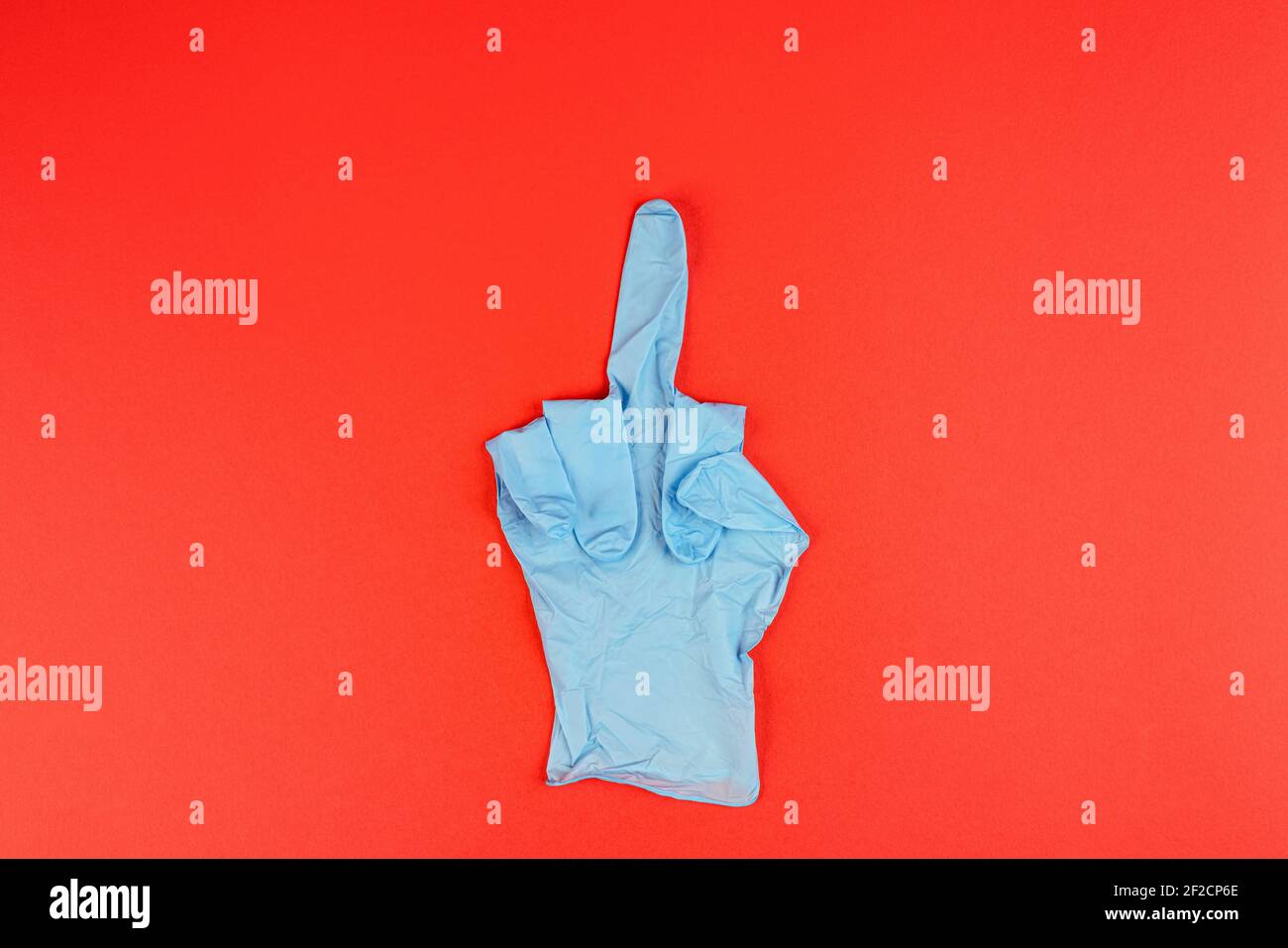 the gesture of indicating the middle finger made with a latex glove Stock Photo