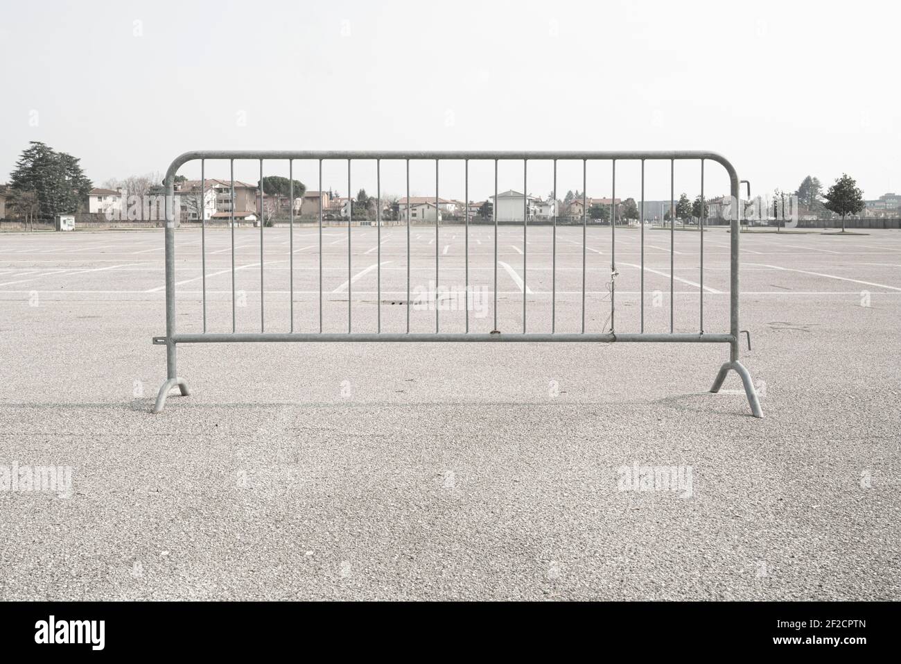 a mobile metal road barrier in an empty parking lot Stock Photo