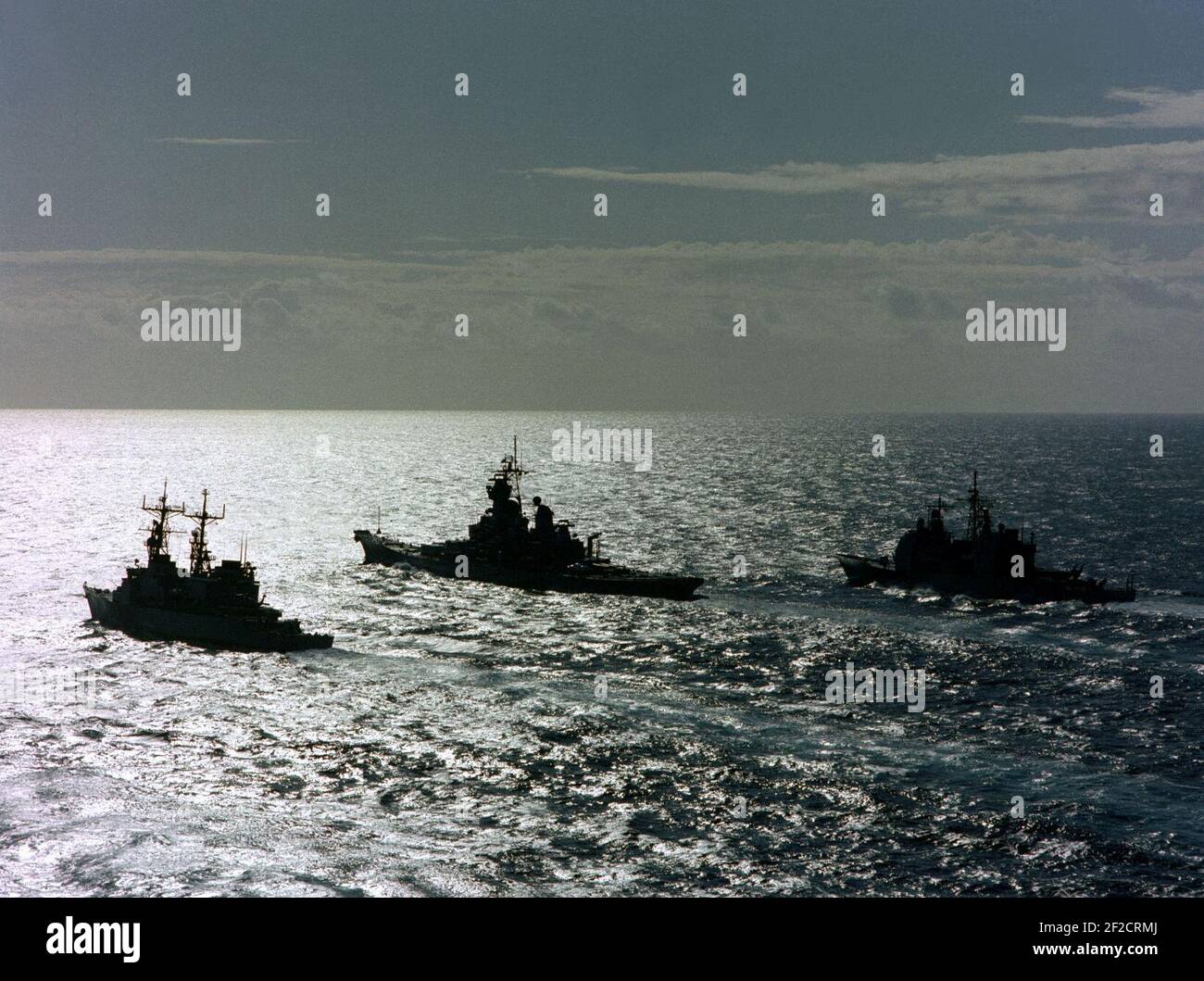 Port quarter silhouette view of USS Ticonderoga (CG47), USS Iowa (BB