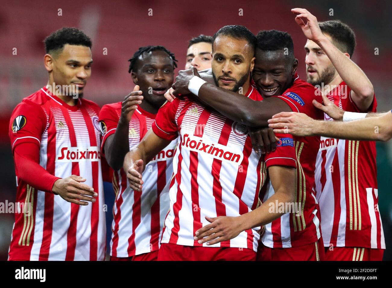 Olympiacos' Youssef El Arabi (centre) celebrates with his team-mates after scoring their side's first goal of the game during the UEFA Europa League round of sixteen, first leg match at the Karaiskakis Stadium, Greece. Picture date: Thursday March 11, 2021. Stock Photo
