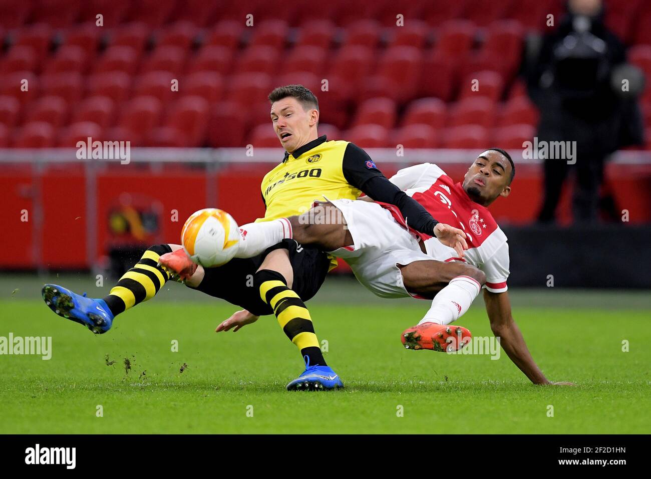 AMSTERDAM , NETHERLANDS - MARCH 11: Christian Fassnacht of Young Boys, Ryan Gravenberch of Ajax during the Ajax v BSC Young Boys - UEFA Europa League Stock Photo