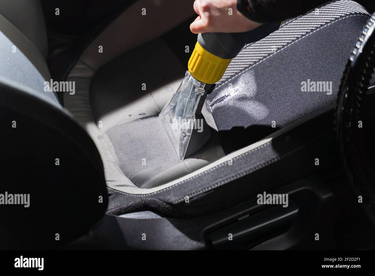 Cleaning car salon dry cleaning with vacuum cleaner. Professional use