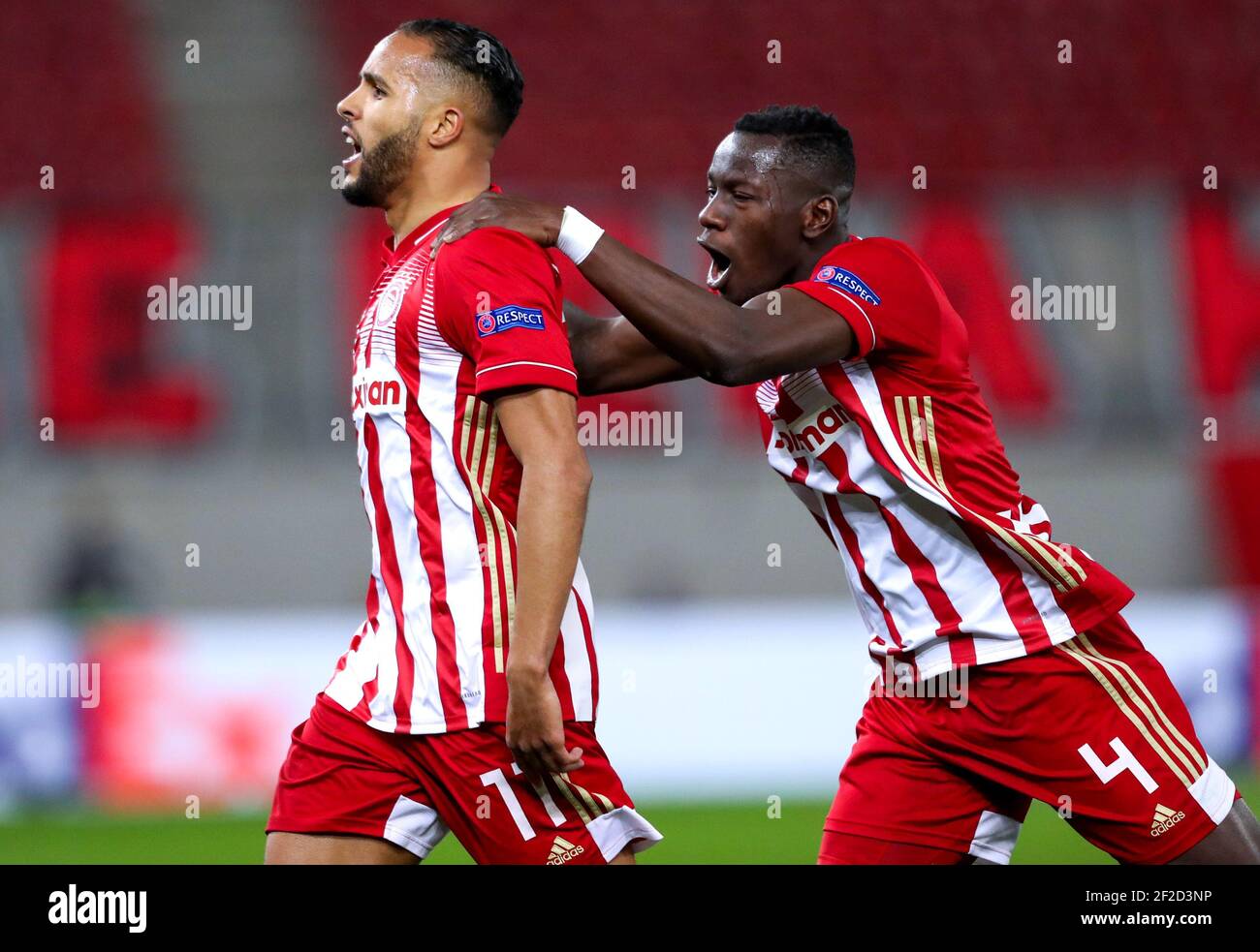 Olympiacos' Youssef El Arabi (left) celebrates scoring their side's first goal of the game during the UEFA Europa League round of sixteen, first leg match at the Karaiskakis Stadium, Greece. Picture date: Thursday March 11, 2021. Stock Photo