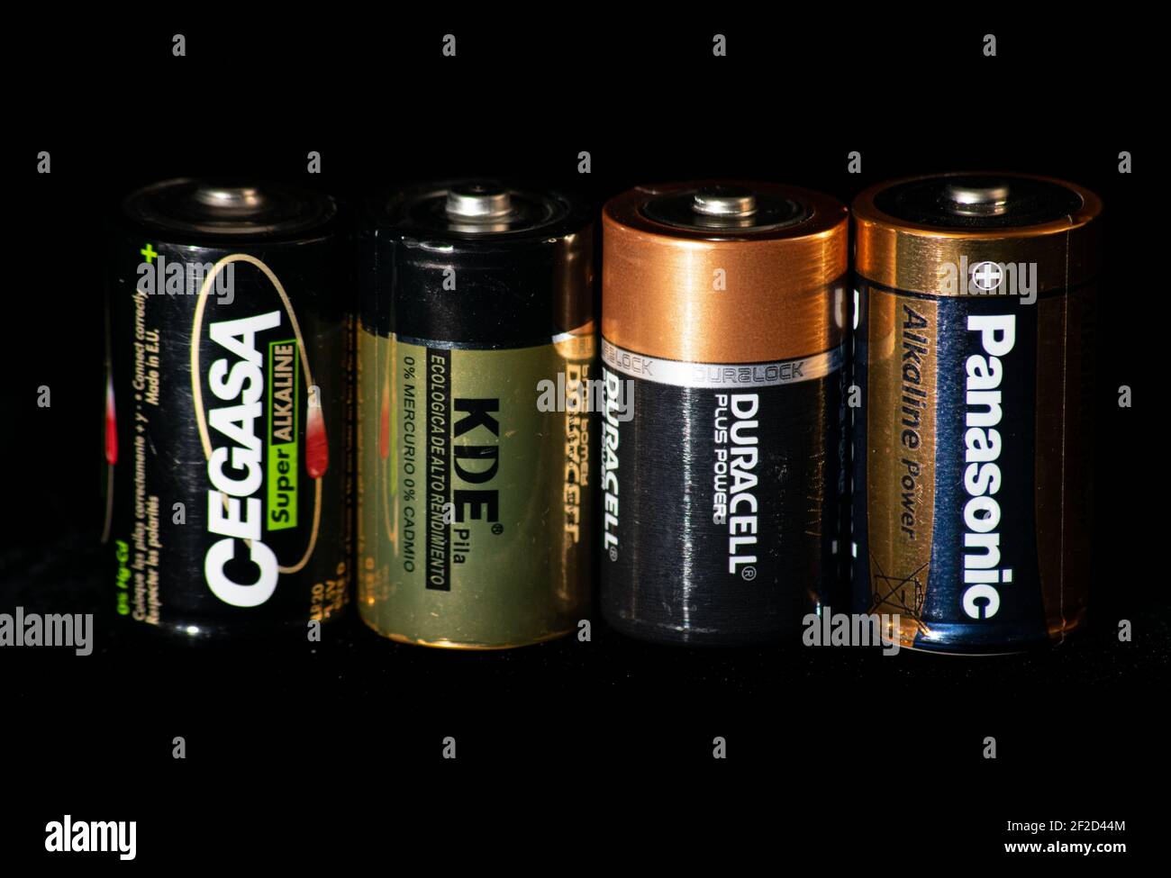Used dry batteries cells D type 1.5 volt from different brands over a black background. Acid batteries used im toys and technology. Stock Photo