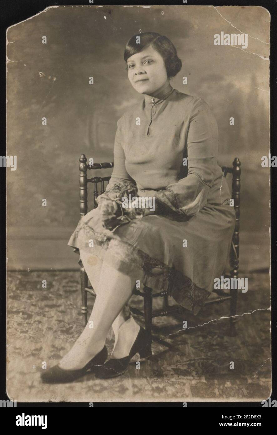 Portrait of a woman sitting in a chair, facing left Stock Photo Alamy