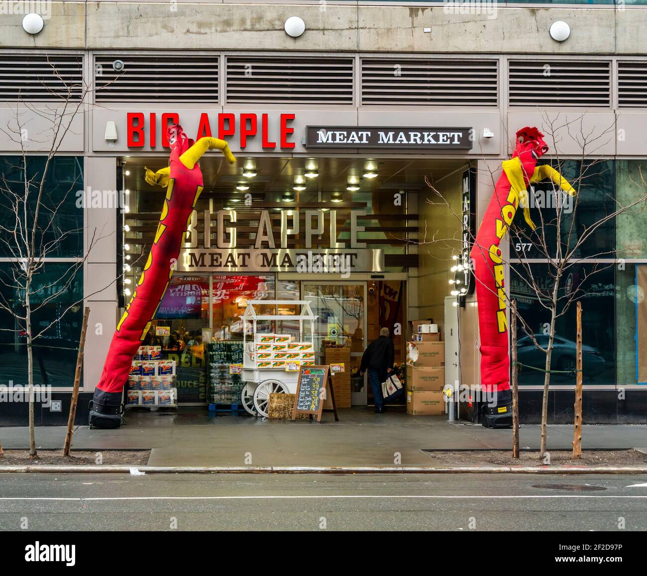 Inflatable figures welcome customers to the Big Apple Meat Market supermarket in the Hell’s Kitchen neighborhood of New York on Saturday, February 27, 2021. (© Richard B. Levine) Stock Photo