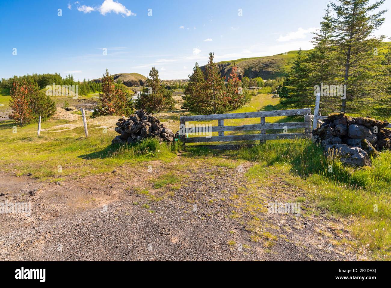 Old wooden farm gate in the countryside of Iceland on a clear summer day Stock Photo
