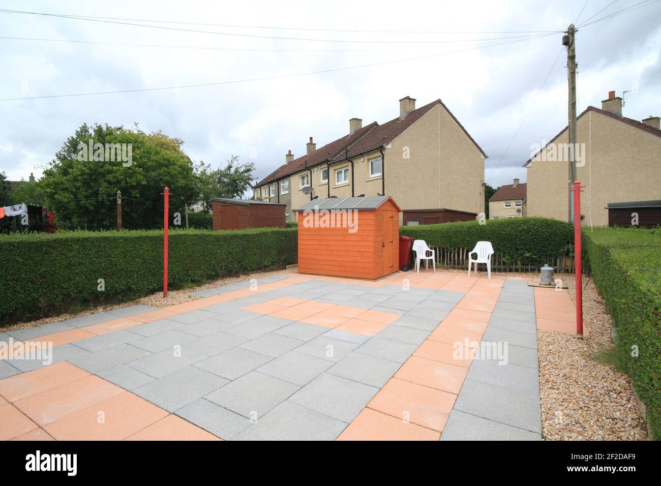 back garden with different coloured concrete paving slabs Stock Photo