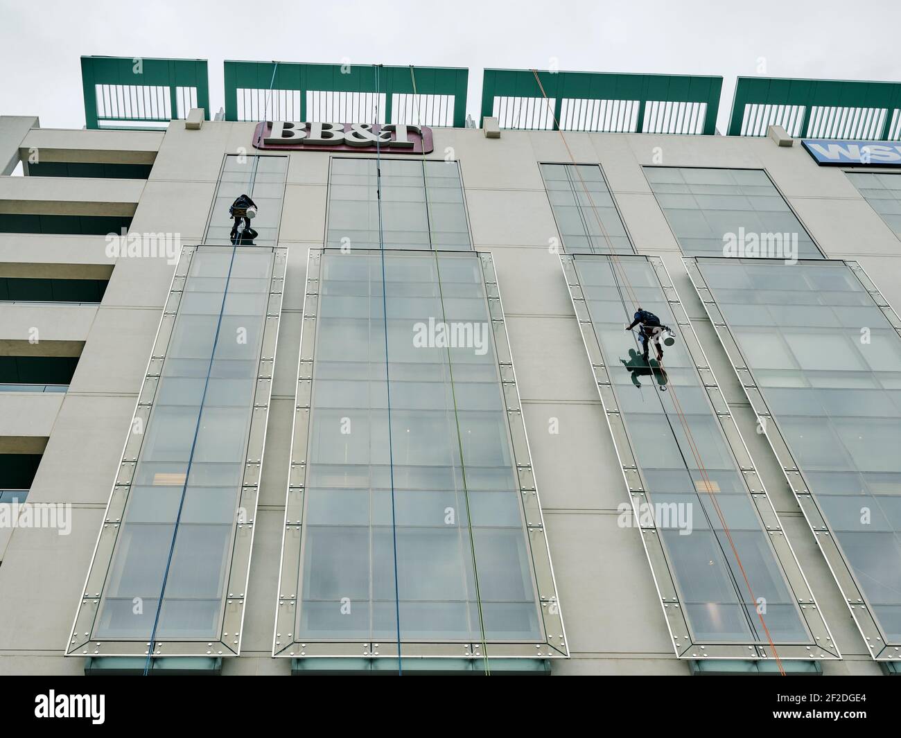Window washer cleaning the outside windows of a high rise building from