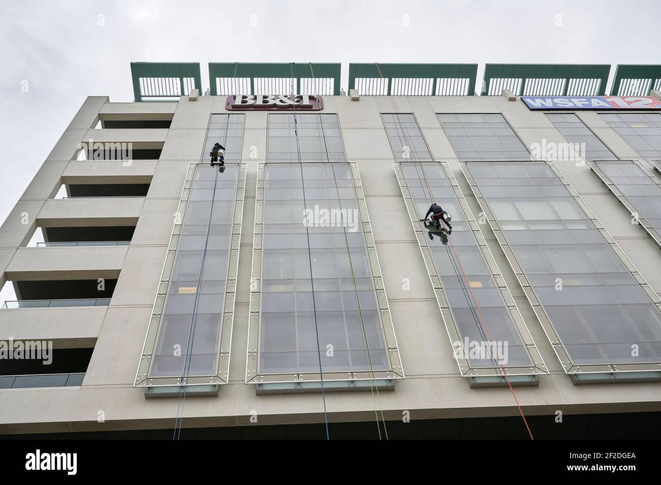 Window washer cleaning the outside windows of a high rise building from