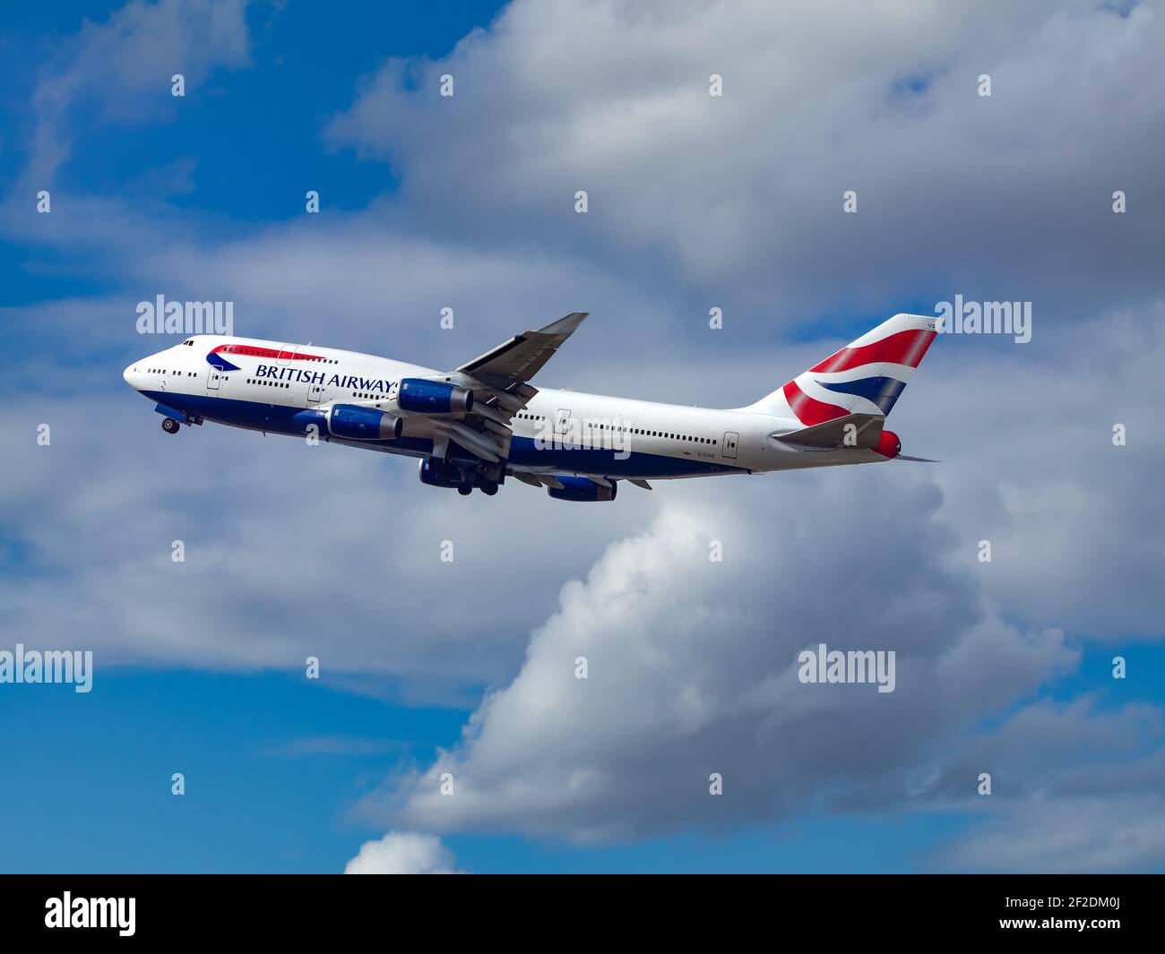 London, UK, August 2019 - British Airways Boeing 747-400 Jumbo Jet Taking off with its Landing gear partially retracted on a sunny and contrasty day. Stock Photo