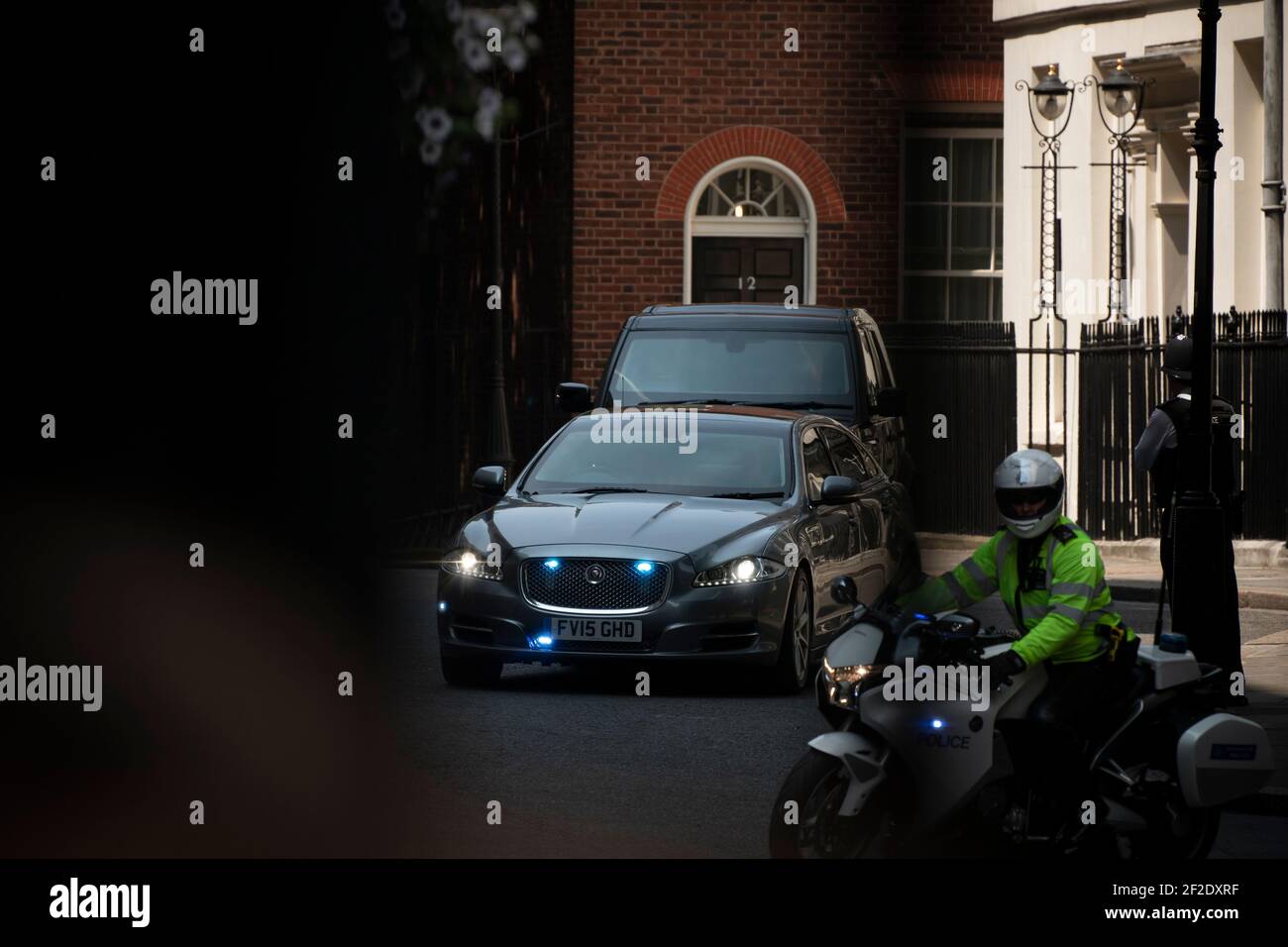 Police escorting the Prime Minister out of Downing Street. Stock Photo