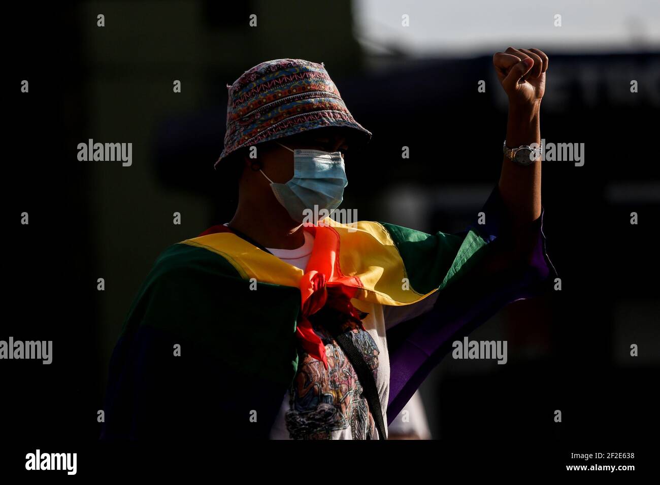 A woman wears a rainbow flag as members of an LGBT (Lesbians Gays Bisexual Transgender) group protest against the early release of US soldier Joseph Scott Pemberton at the Boy Scout Circle in Quezon City, Metro Manila, Philippines. Stock Photo