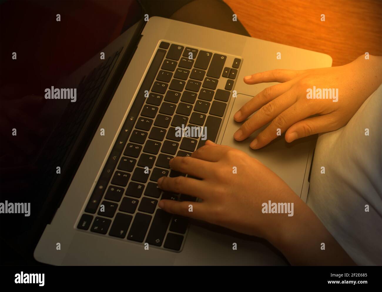 Girl hand typing laptop keyboard in concept coffee shop Wireless data entry and technology. Stock Photo