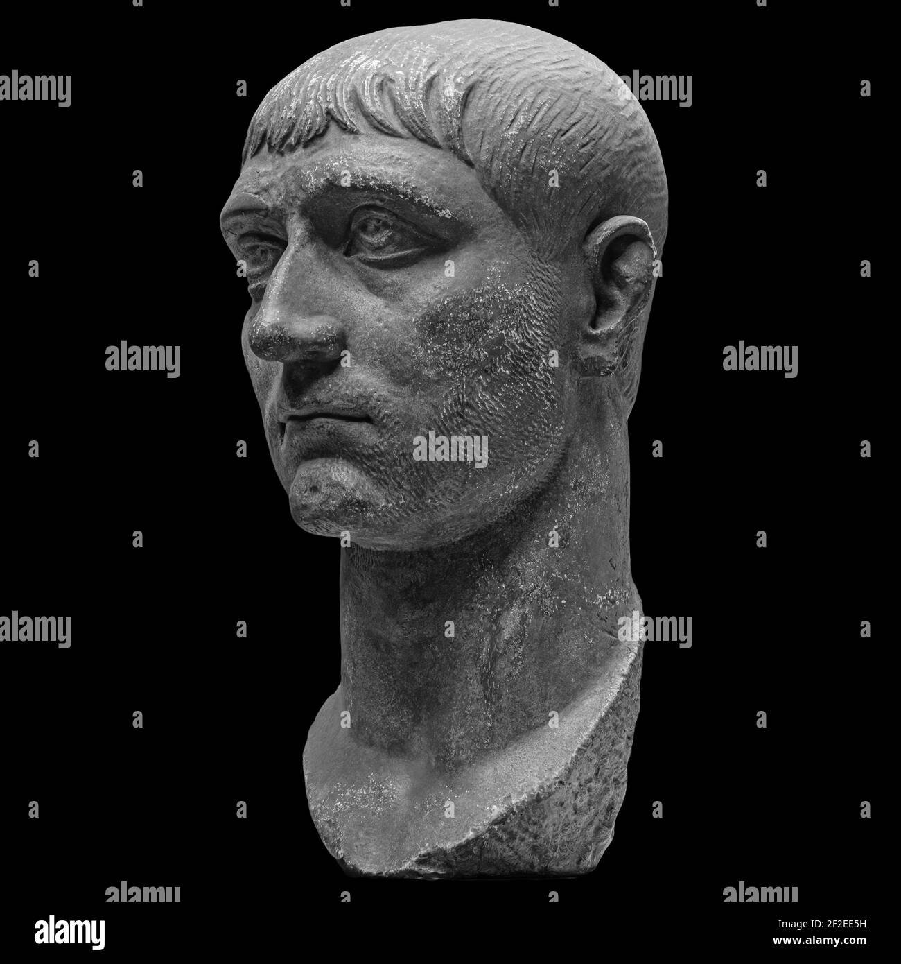 Head detail of the ancient man sculpture. Stone face isolated on black background. Antique