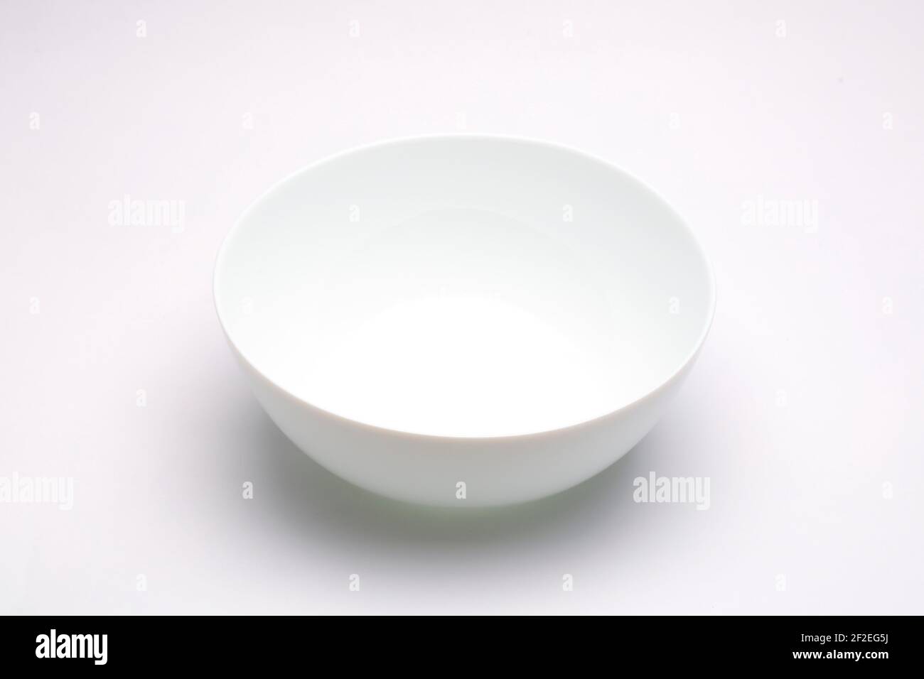 White bowl ,empty white bowl arranged on white textured background. Stock Photo
