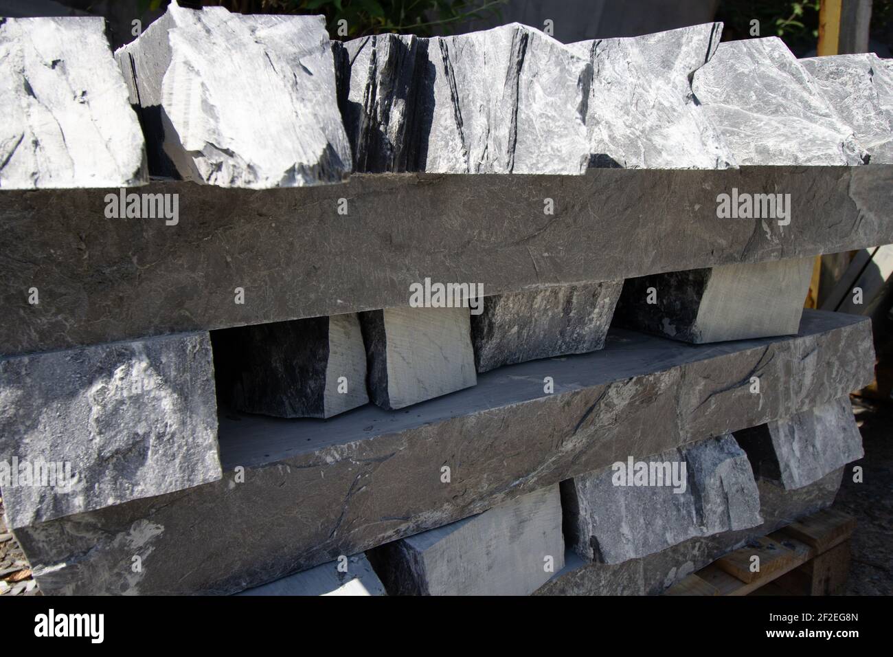 raw slate stacked neatly ready for cutting into roof tiles Stock Photo