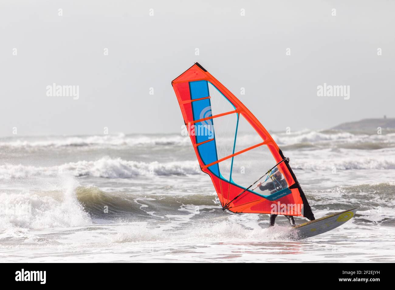 Garrylucas, Cork, Ireland. 11th March, 2021. In the aftermath of an overnight storm a winsurfer takes advantage of the high winds and rough seas at Garrylucas, Co. Cork, Ireland.  - Credit; David Creedon / Alamy Live News Stock Photo