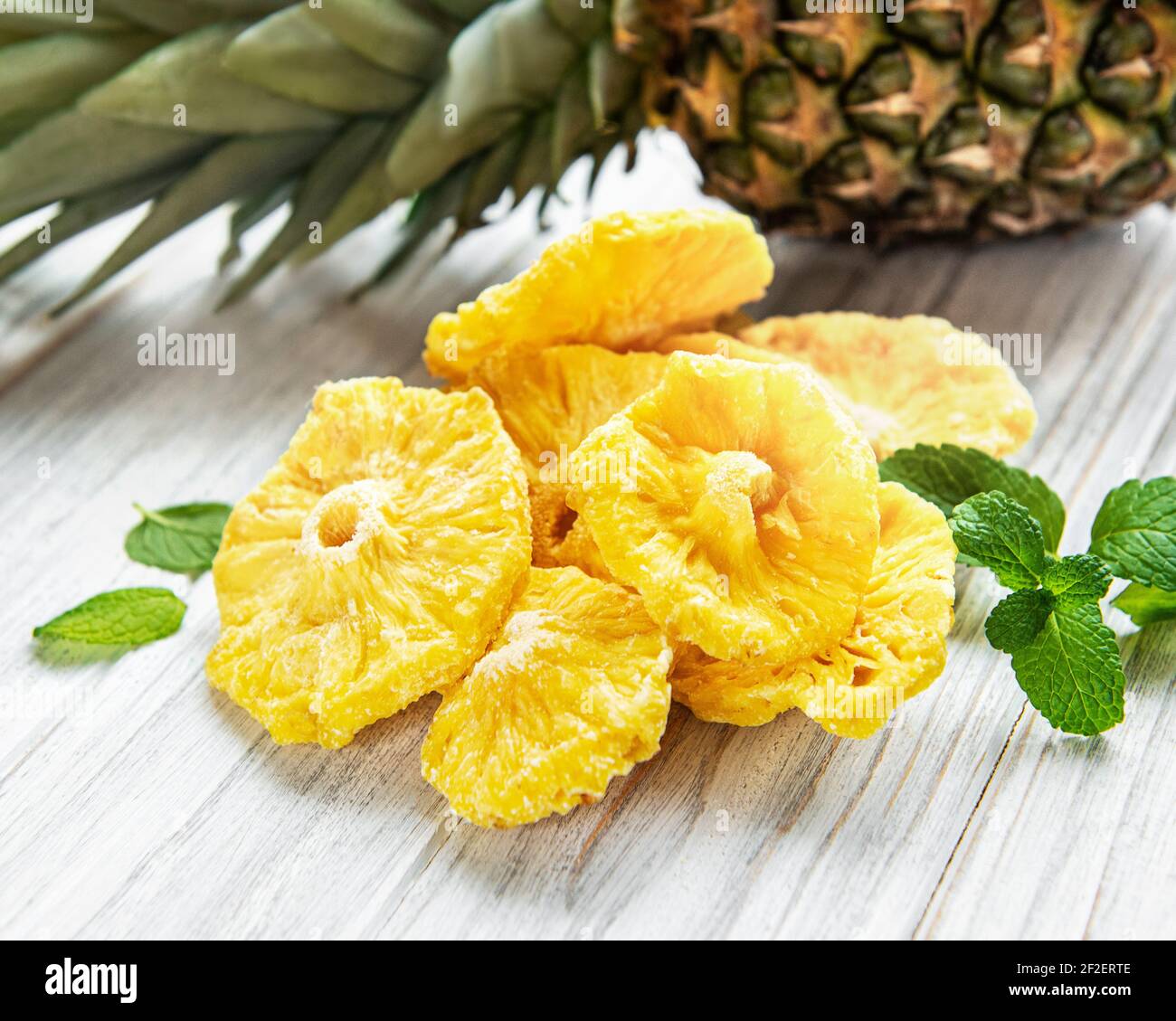 Pineapple dried rings on rustic wooden background Stock Photo