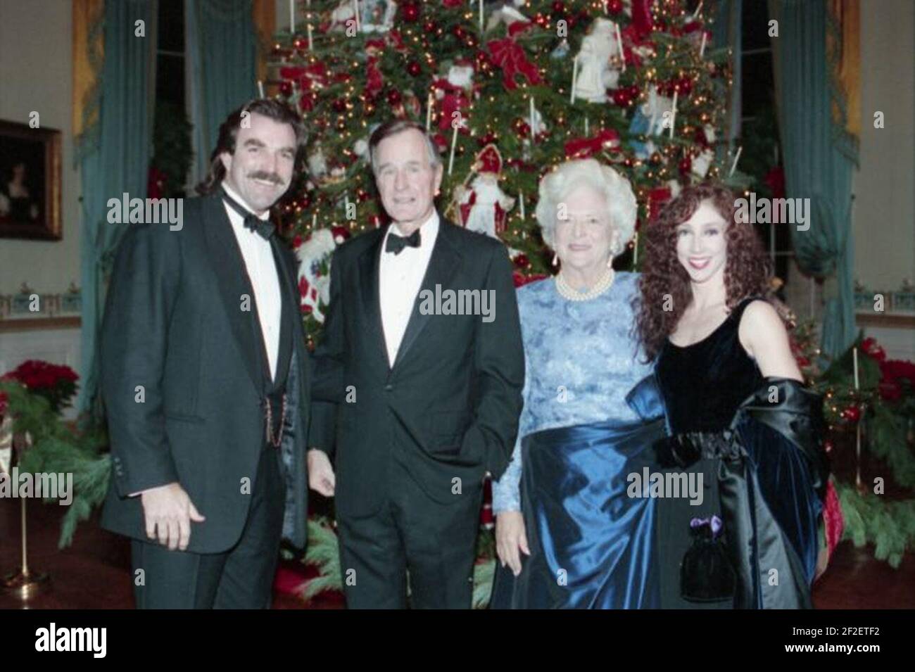 President George H. W. Bush and Barbara Bush pose for a picture with Tom Selleck and his wife at a reception for Kennedy Center Honorees. Stock Photo