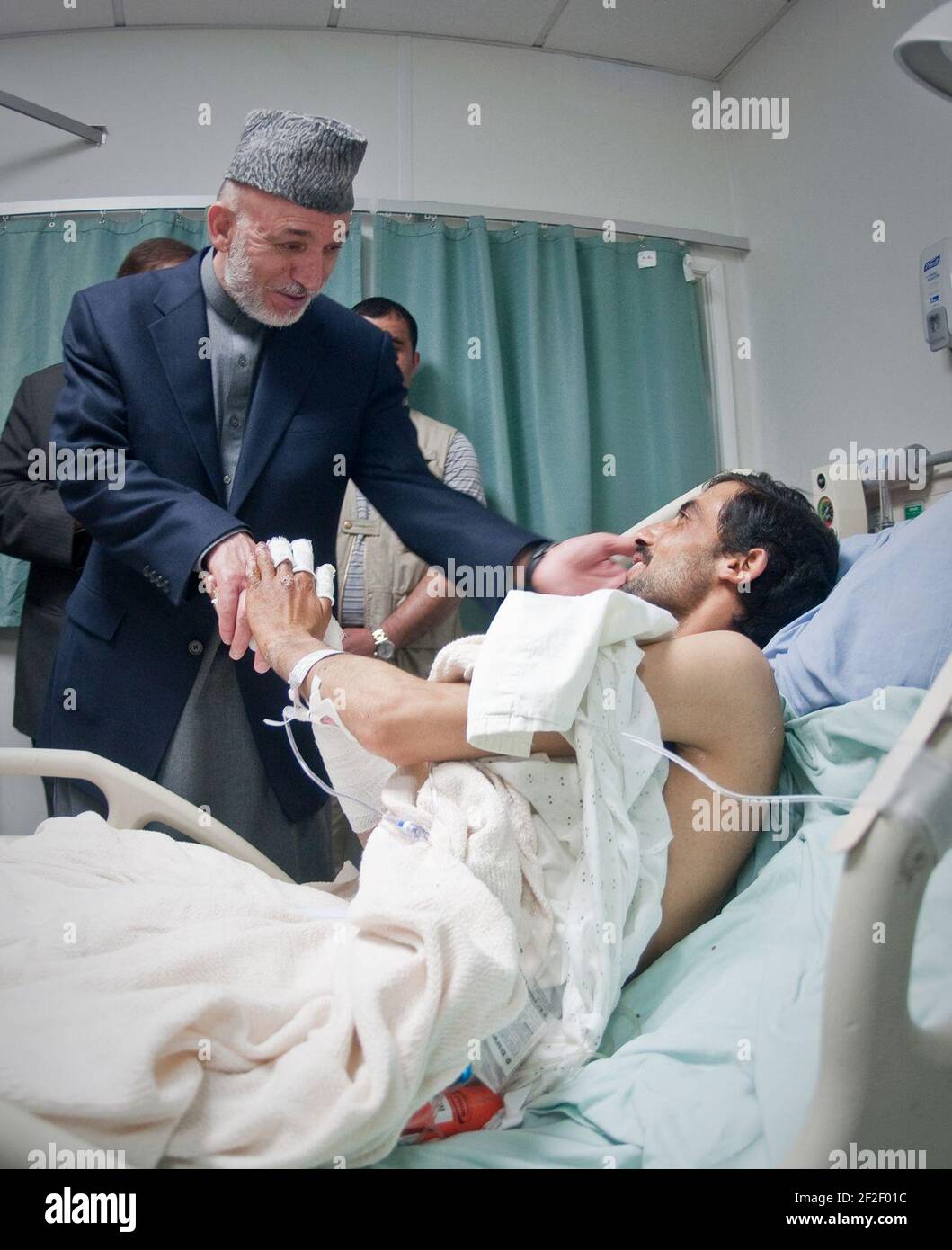 President Karzai Visits Wounded Afghan Soldier Stock Photo