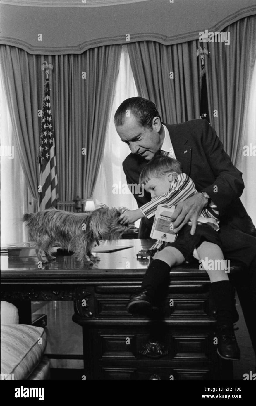 President Richard Nixon and Michael Newton, Better Hearing and Speech Month Poster Child, in the Oval Office with Pasha, the Nixons' Yorkshire Terrier. Stock Photo