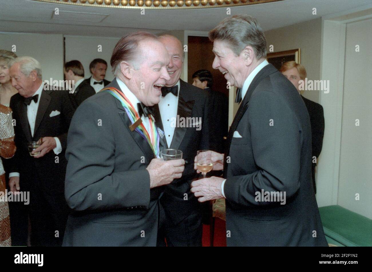 President Ronald Reagan and Bob Hope laughing with George Shultz. Stock Photo