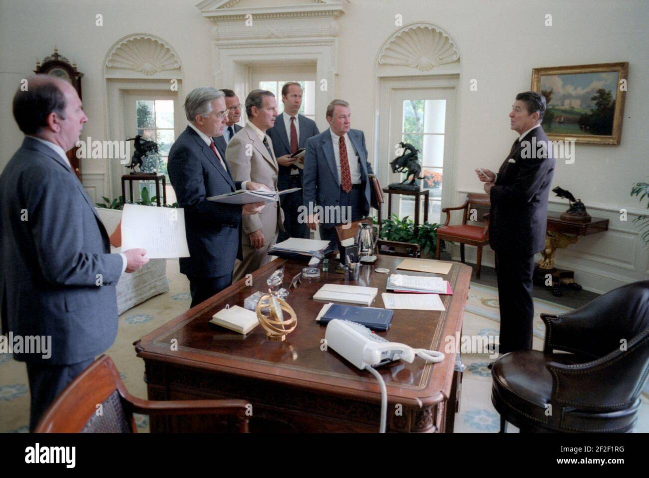 President Ronald Reagan and his White House staff discuss the