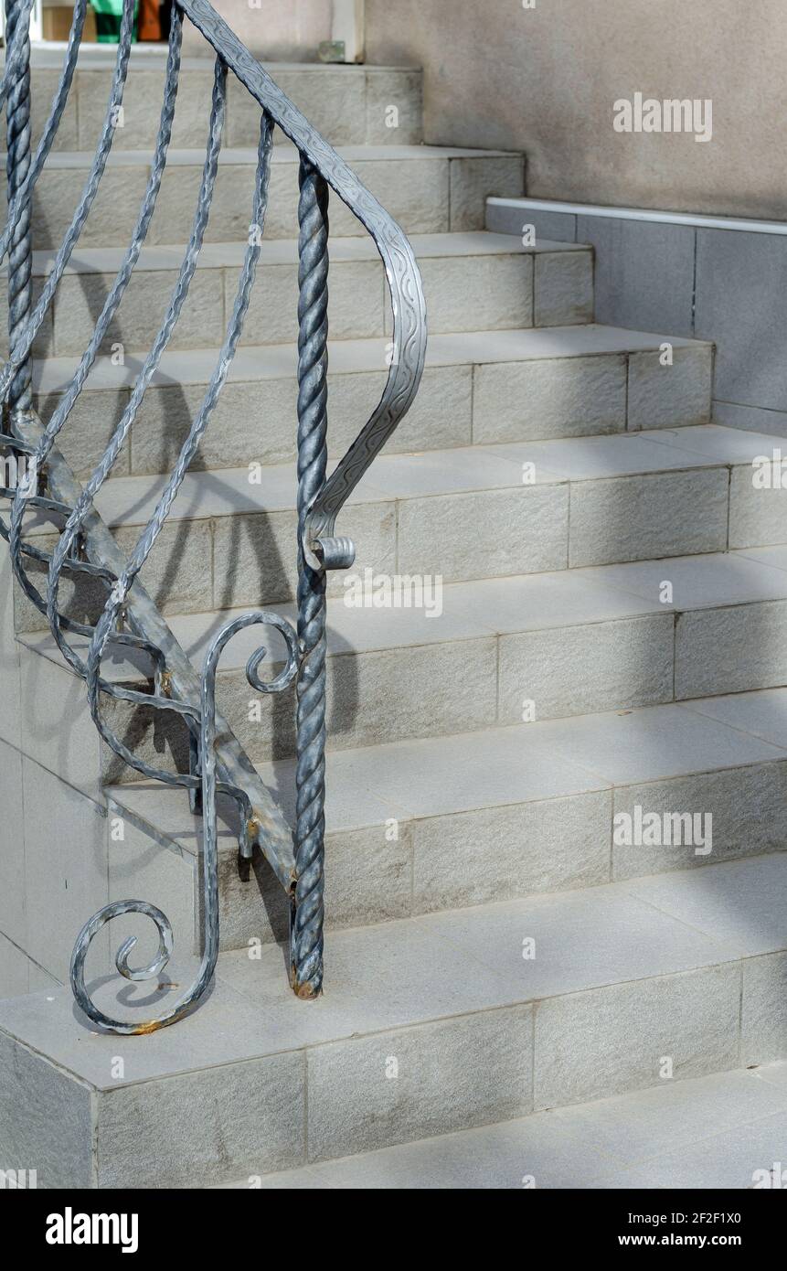 Gray stone staircase with wrought iron railings. Graceful railings ...