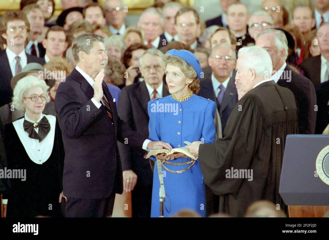 President Ronald Reagan Being Sworn In For A Second Term By Chief Justice Warren Burger As Nancy 