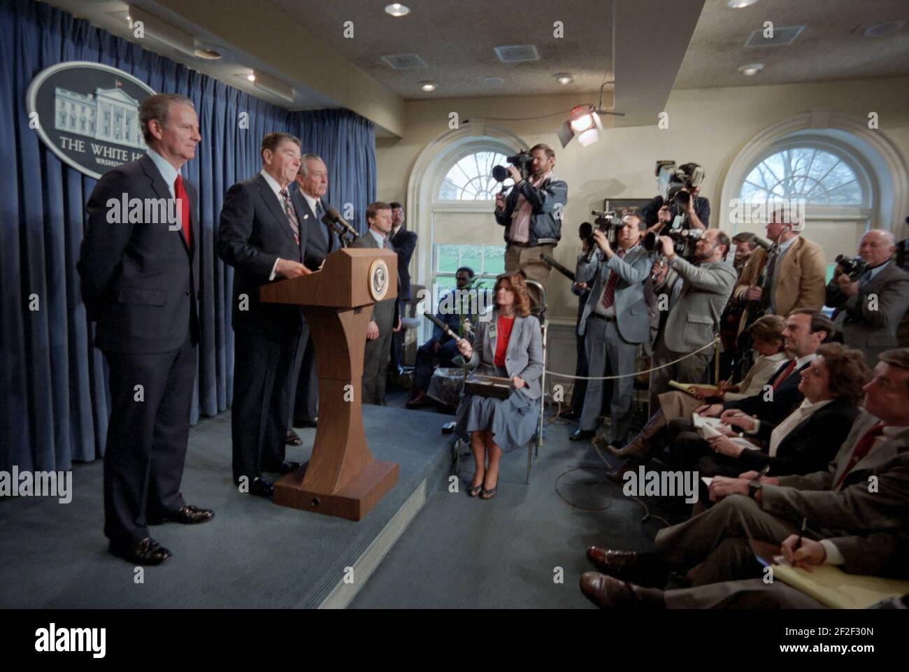President Ronald Reagan making a statement to the press announcing the nomination of James Baker to be Secretary of the Treasury and the appointment of Donald Regan as Chief of Staff in the Press Briefing Room. Stock Photo