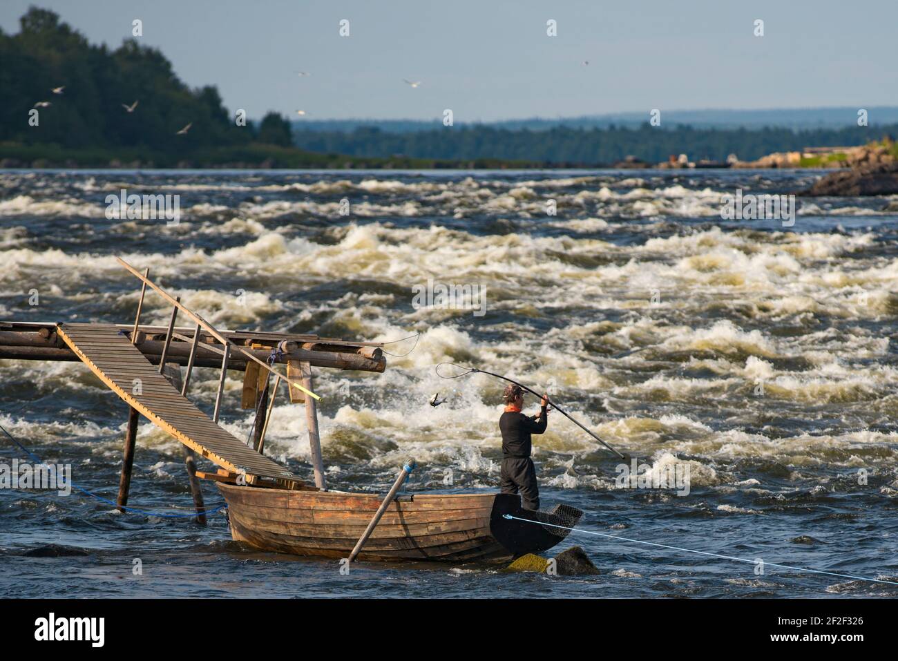 Fishing in Kukkola River between Sweden And Finland Stock Photo