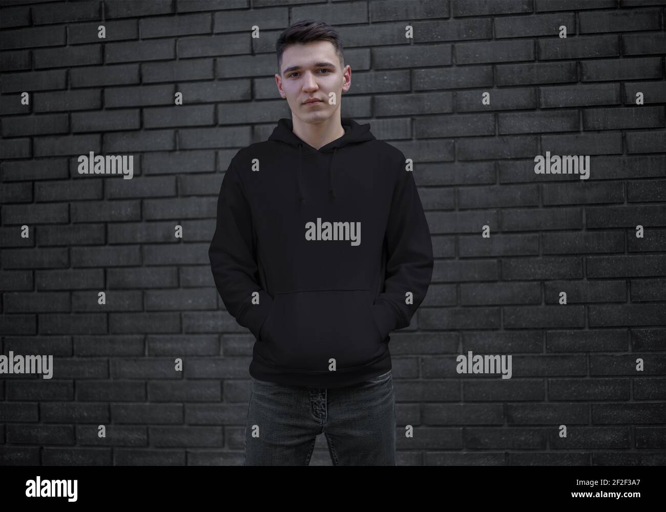 Download Mockup Of A Black Hoodie With A Pocket On A Young Guy In Jeans Front View Long Sleeve Sweatshirt For Design Presentation Template Of Men S Clothing Stock Photo Alamy