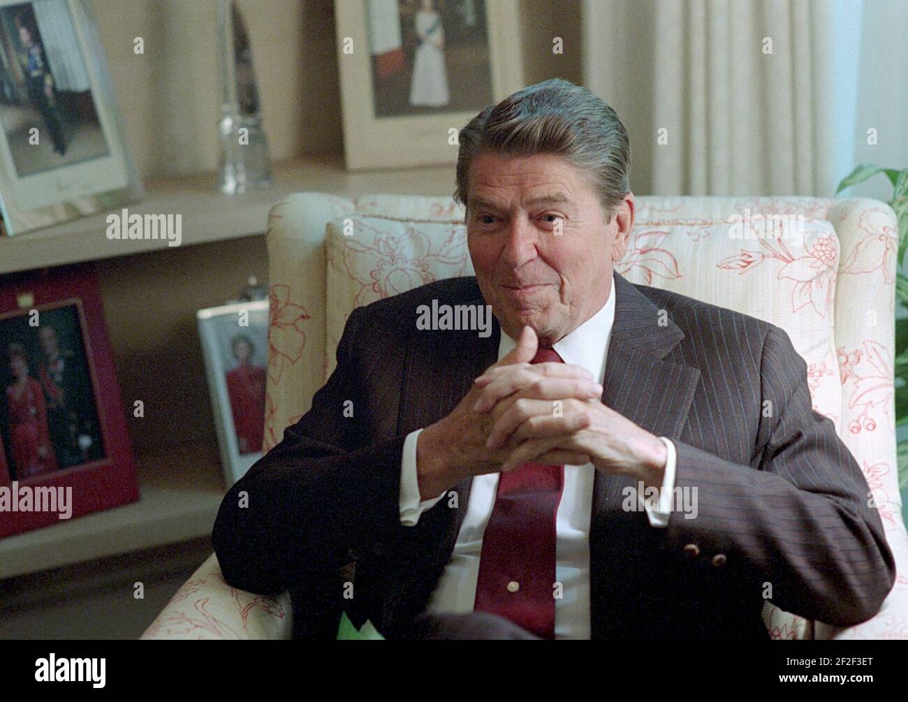 President Ronald Reagan sitting in the Oval Office Study. Stock Photo